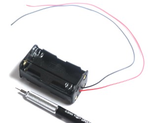 4 AA Battery Holder with Wire Leads shown with mechanical pencil for scale.