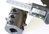 1/2 to 3/4 steel rigid coupling shown with a caliper. The measurement reads 1.7185 inches. 