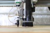 Fabricator Pro CNC Router machine view of the z axis lower part with the CO2 laser nozzle, spindle and the dust shoe