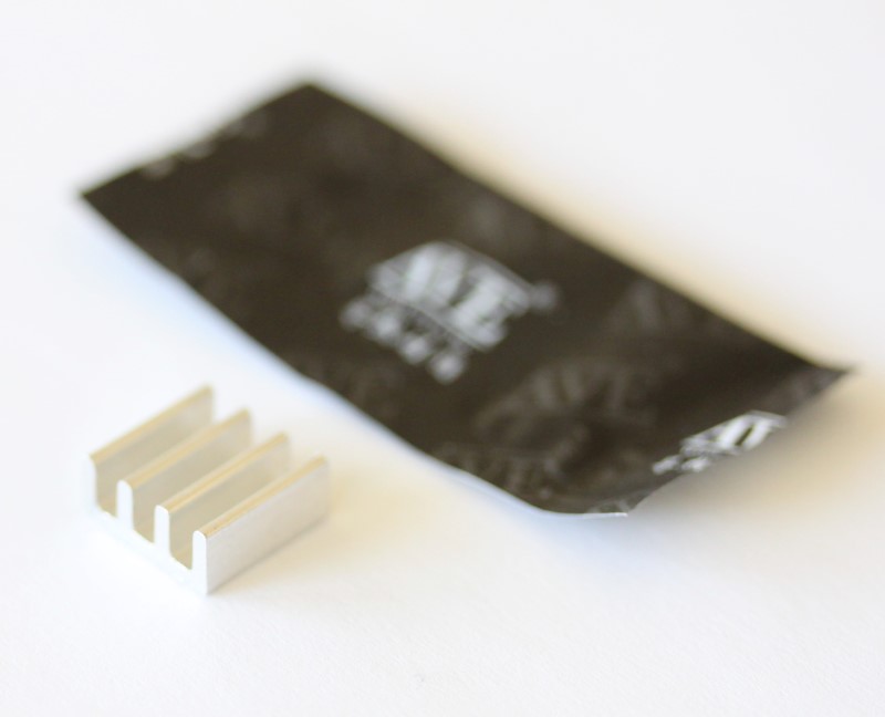 small aluminum heat sink and a packet of thermal compound