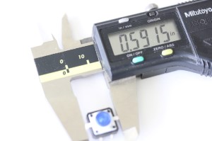 LED button shown with a caliper. The measurement reads .5915 inches.