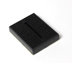 A single mini breadboard 17X10. Black color.