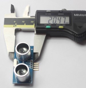 Picture shows the width of an Ultrasonic Range Finder Distance Measurement Sensor, measuring 20.47 mm.